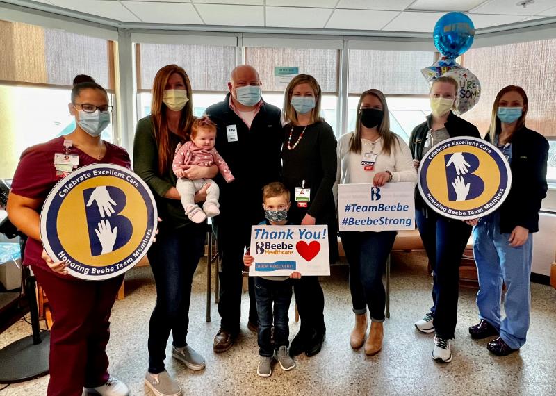 Gathered to celebrate the Adams family’s excellent delivery experience at Beebe Healthcare are (l-r) Keli Lyn Jordan, CNA; Emily Hendrickson, RN, holding Delaney Adams; Nick and Stephanie Adams; Liam Adams holding Thank You sign; Kelsi Warrington, RN; Addie Baunchalk, RN; and Stacey Churchill, RN. Not available for the photo are Autumn Ralph, RN; Cheryl Cowan, CRNA; and Dr. Angela Caswell-Monack. SUBMITTED PHOTO